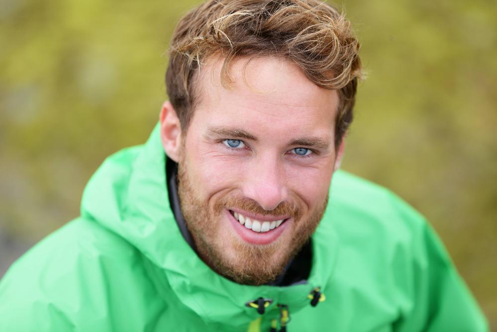 man in green jacket smiling | teeth whitening foothill ranch ca